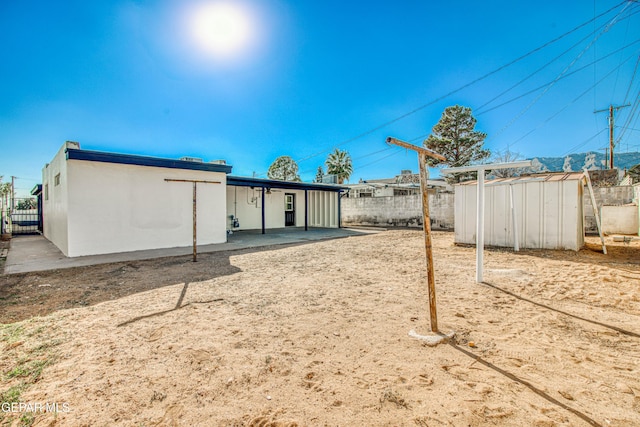 view of yard with a patio area and a storage shed