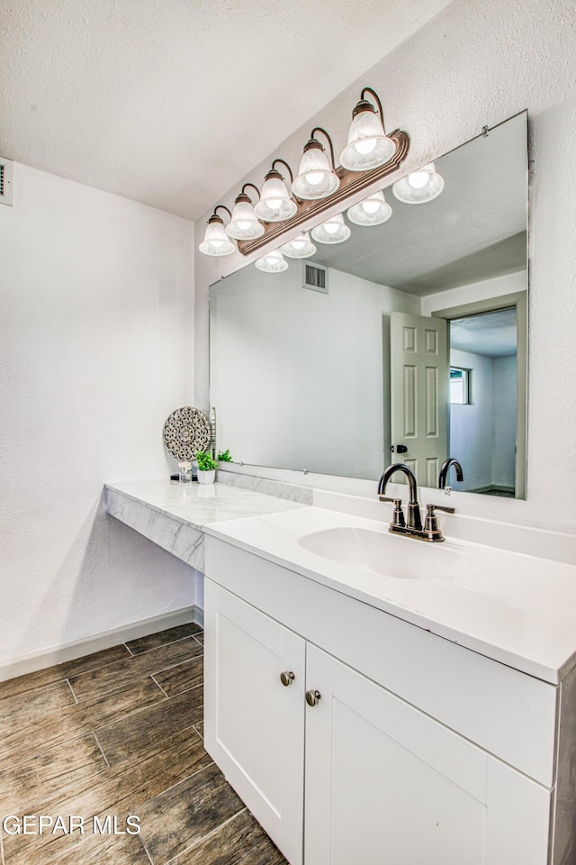 bathroom with vanity and a textured ceiling