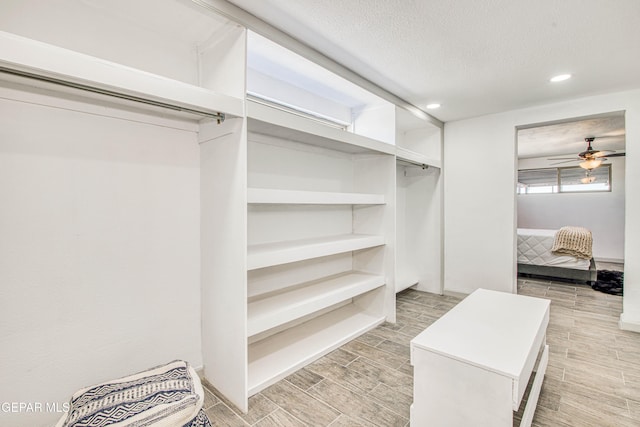 spacious closet with ceiling fan