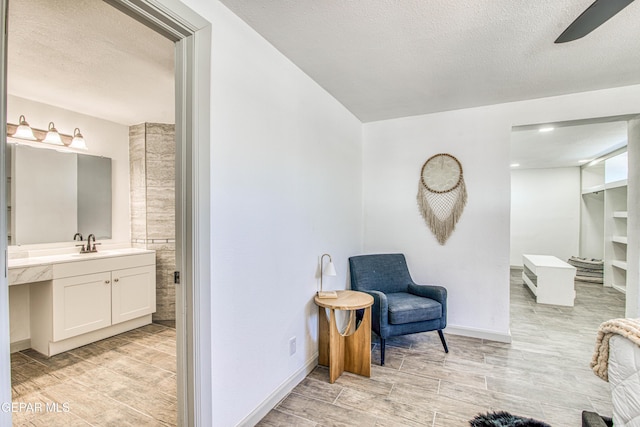 bathroom with a textured ceiling and vanity