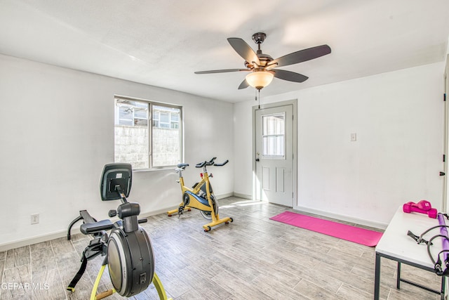 workout area featuring ceiling fan and light hardwood / wood-style flooring