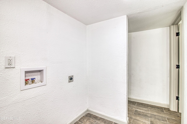 washroom with hookup for a washing machine, a textured ceiling, and electric dryer hookup