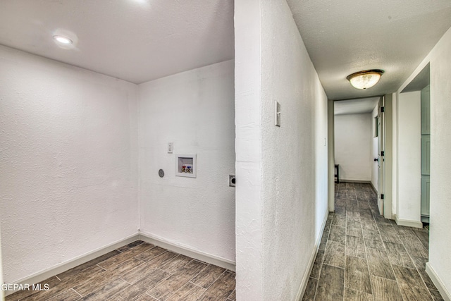 laundry room with electric dryer hookup, washer hookup, and a textured ceiling