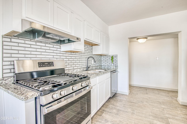 kitchen featuring sink, white cabinets, stainless steel appliances, and extractor fan