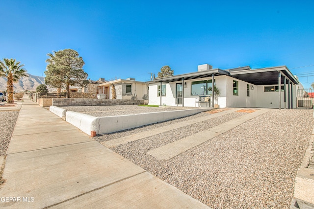 view of front facade featuring a carport and a mountain view