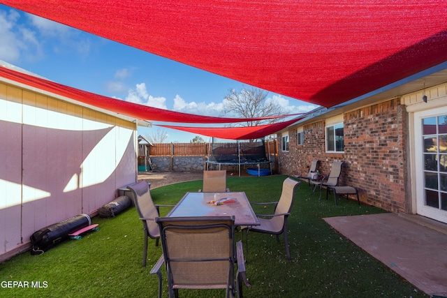 view of yard featuring a patio area and a trampoline