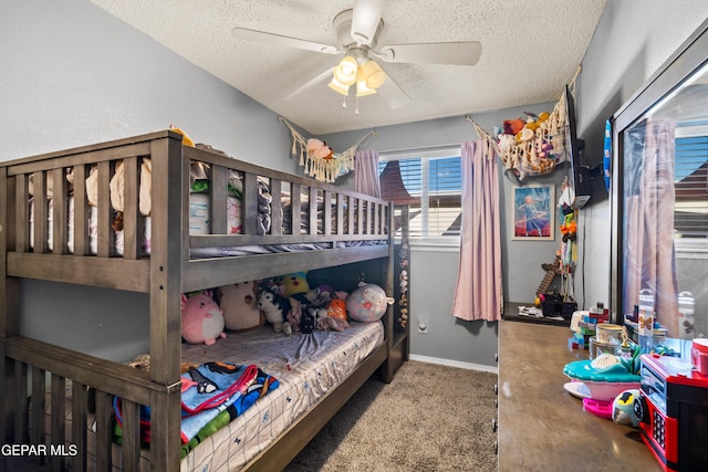 carpeted bedroom with a textured ceiling and ceiling fan