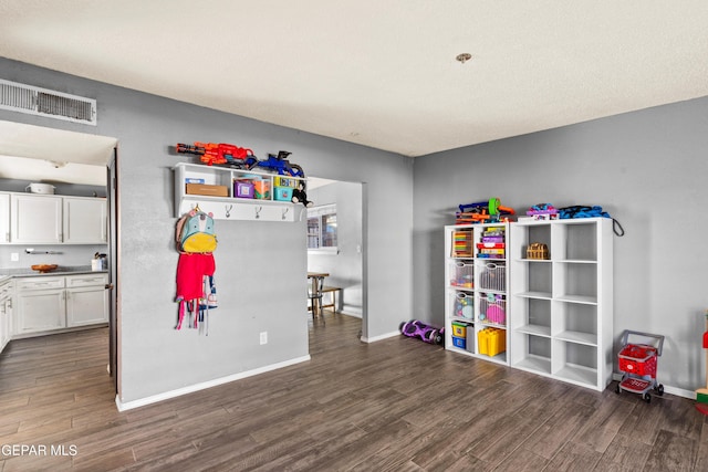 game room with dark hardwood / wood-style floors