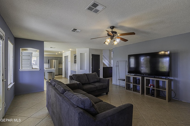 tiled living room featuring ceiling fan