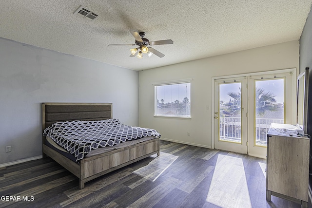 bedroom with a textured ceiling, ceiling fan, access to outside, and dark wood-type flooring