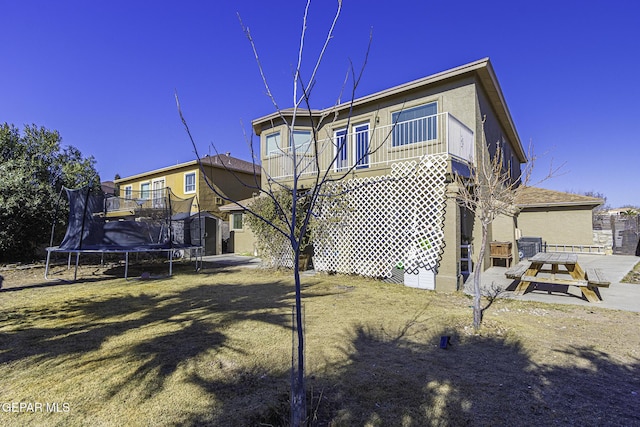 rear view of house with a trampoline