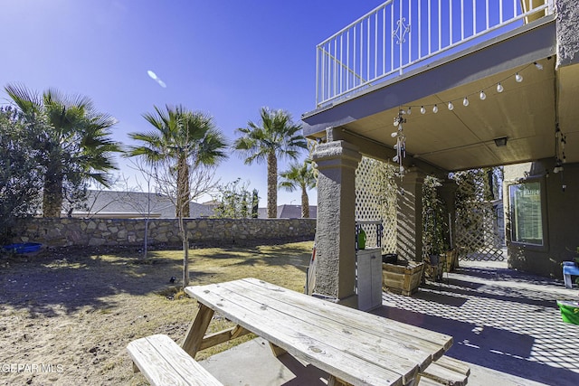 wooden terrace with a patio area