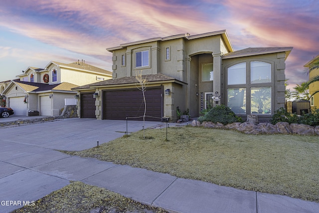 front of property featuring a yard and a garage