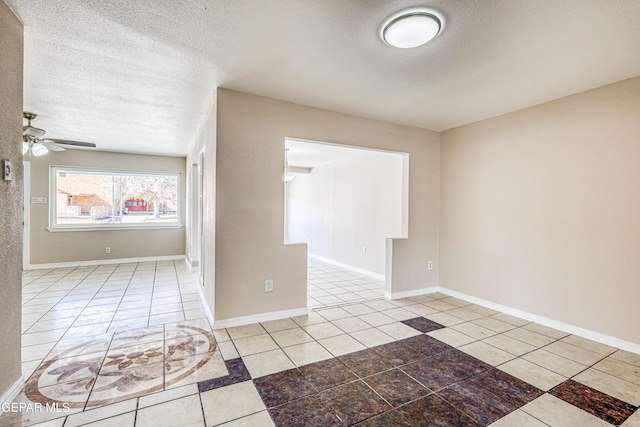 unfurnished room with tile patterned floors, ceiling fan, and a textured ceiling