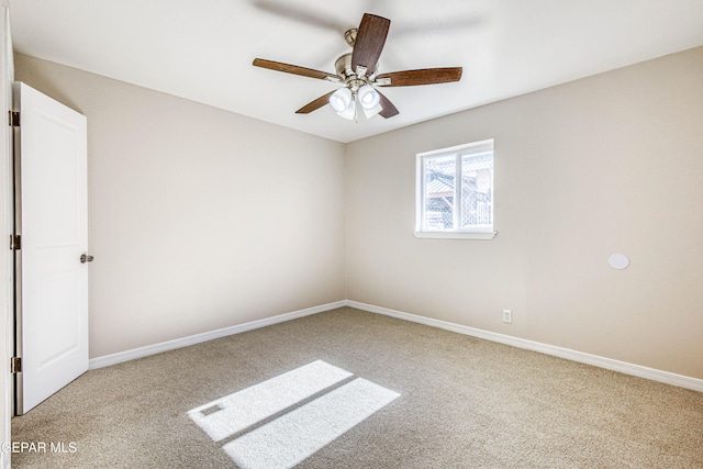 carpeted spare room featuring ceiling fan