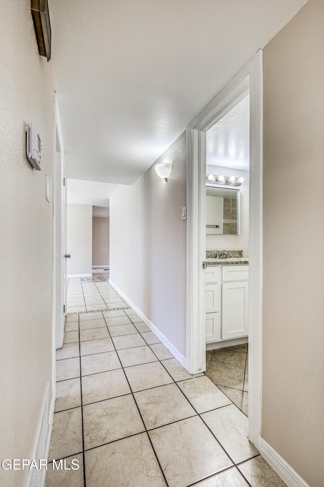 corridor with light tile patterned floors