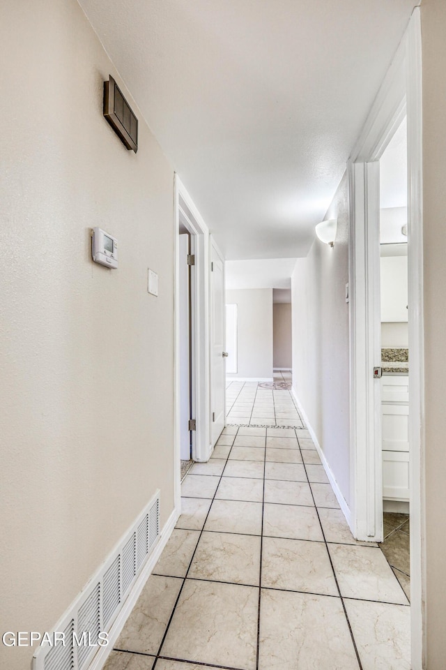 hallway with light tile patterned floors