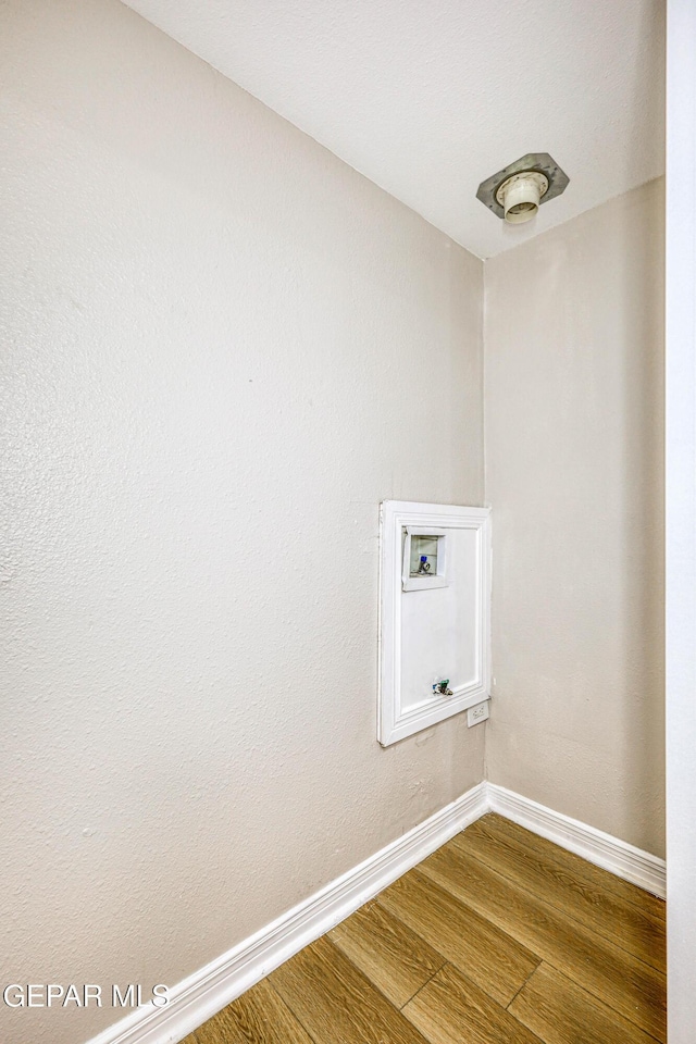 laundry area with hookup for a washing machine and hardwood / wood-style flooring