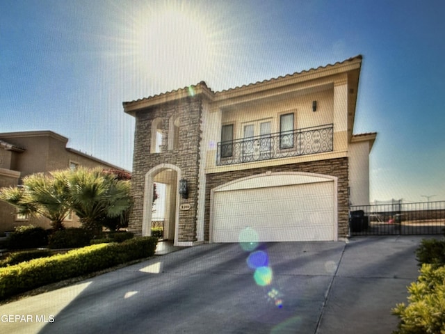 mediterranean / spanish-style house featuring a balcony and a garage