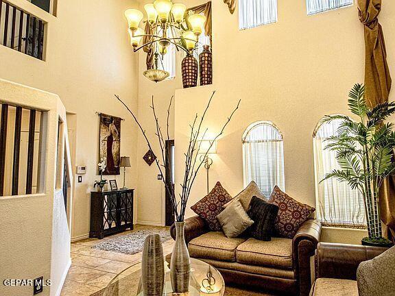 living room with a chandelier and a high ceiling