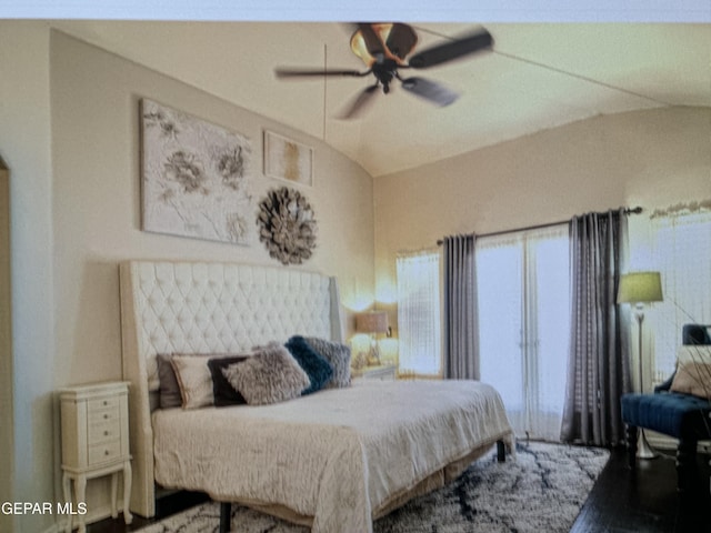 bedroom with hardwood / wood-style flooring, ceiling fan, and lofted ceiling