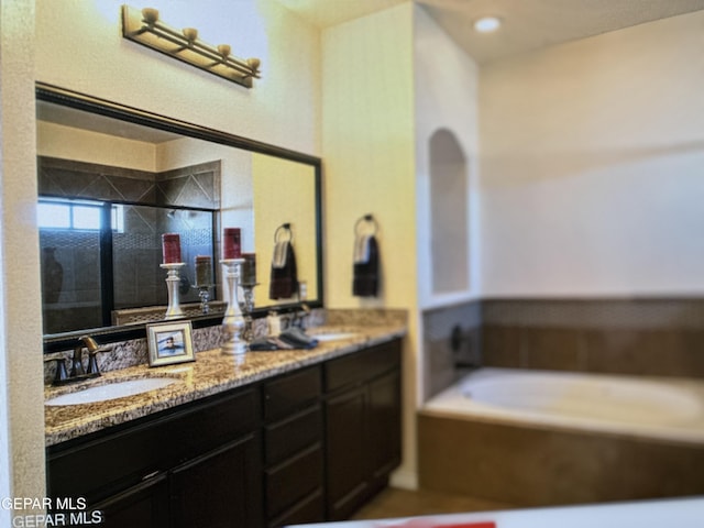 bathroom featuring vanity and separate shower and tub