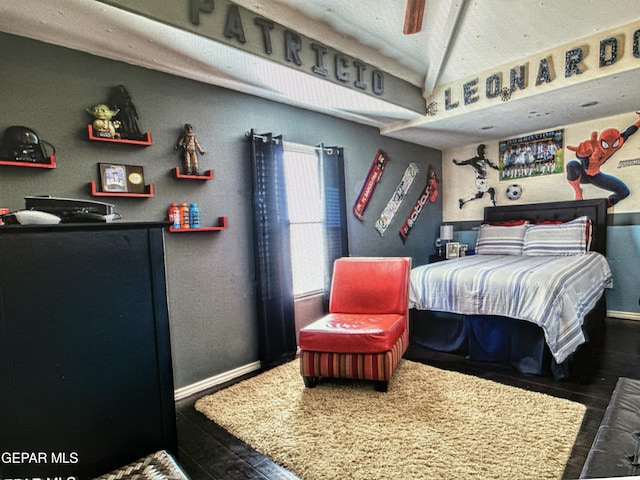 bedroom with ceiling fan and dark wood-type flooring