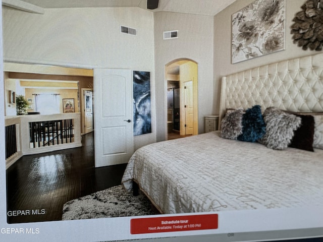 bedroom featuring wood-type flooring and vaulted ceiling