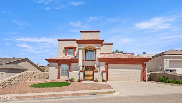 mediterranean / spanish-style home featuring a garage