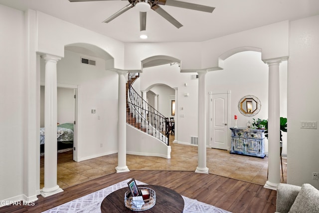 entryway with ceiling fan and wood-type flooring