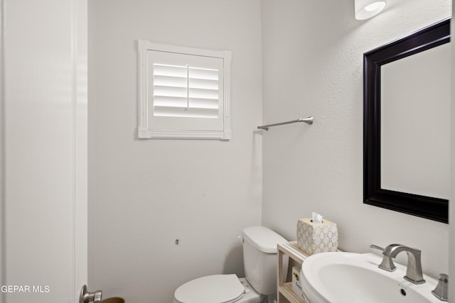 bathroom featuring sink and toilet