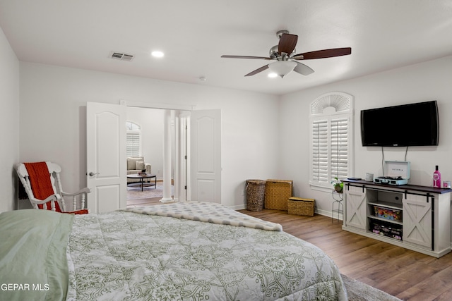 bedroom featuring wood-type flooring and ceiling fan