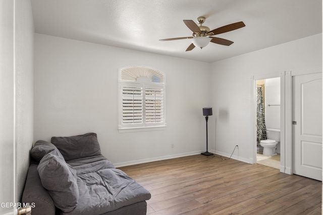 sitting room with ceiling fan and hardwood / wood-style flooring