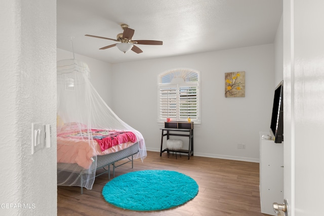 bedroom featuring wood-type flooring and ceiling fan