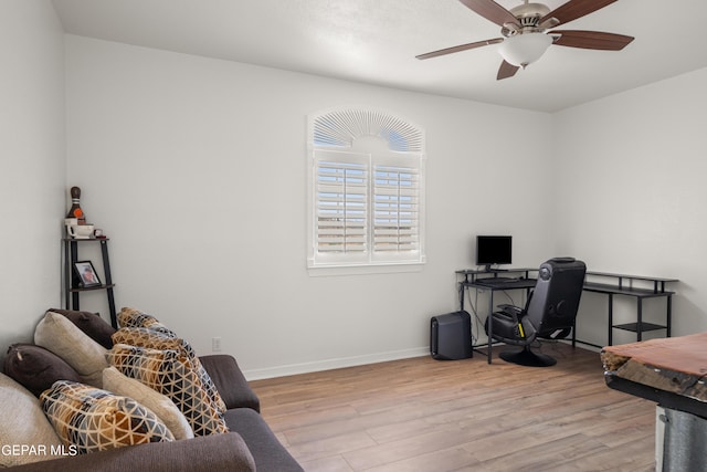 home office featuring ceiling fan and light hardwood / wood-style floors