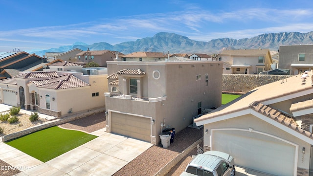 view of front of property with a mountain view and a garage