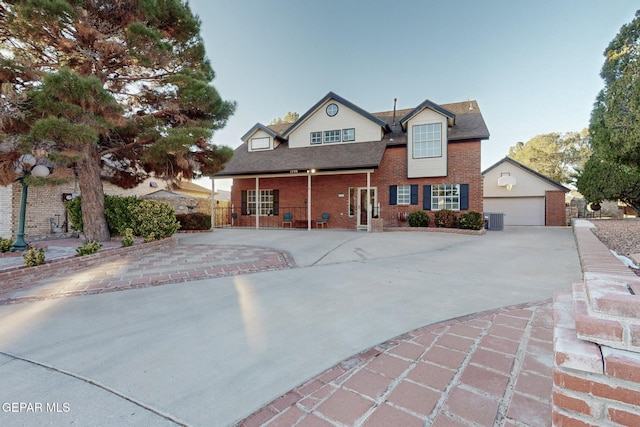 view of front property with central AC and a garage