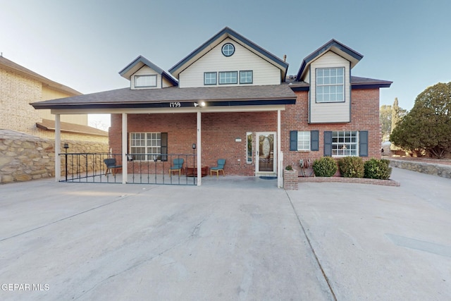 rear view of property featuring a porch