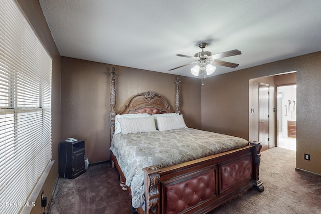 carpeted bedroom featuring ensuite bath and ceiling fan