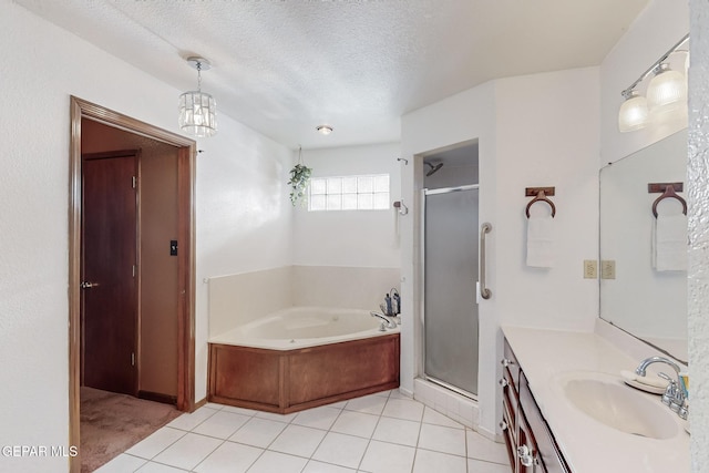 bathroom with a textured ceiling, tile patterned flooring, vanity, and shower with separate bathtub