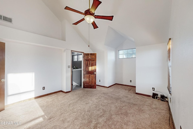 interior space featuring high vaulted ceiling, light carpet, and ceiling fan