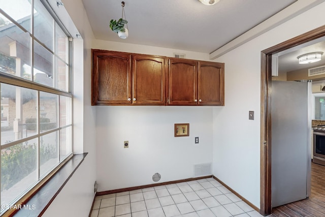 laundry area with cabinets, hookup for a washing machine, and electric dryer hookup