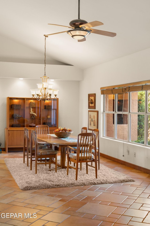 dining room featuring lofted ceiling and ceiling fan with notable chandelier