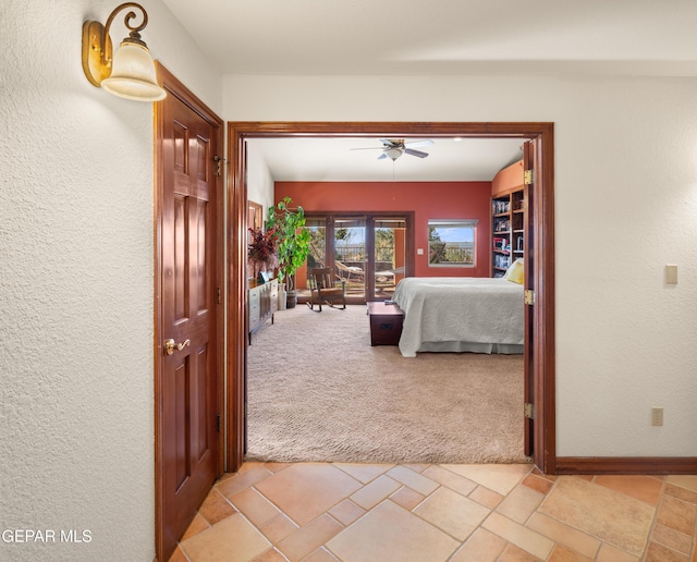 bedroom with ceiling fan and light carpet