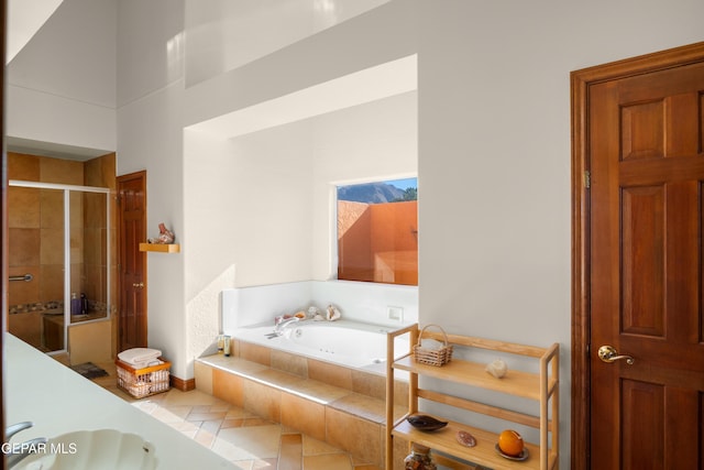 bathroom with tile patterned floors, separate shower and tub, and sink