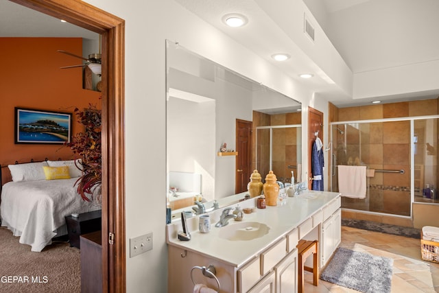 bathroom featuring ceiling fan, an enclosed shower, and vanity