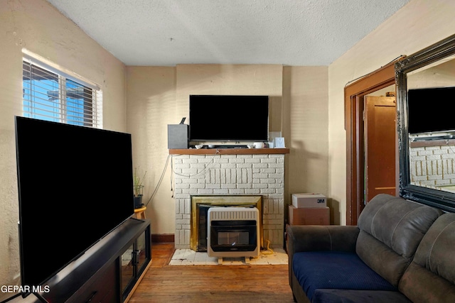 living room featuring a textured ceiling and wood-type flooring