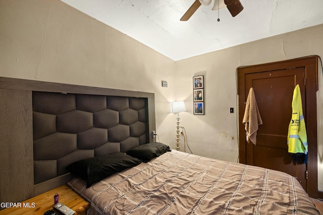 bedroom with ceiling fan and hardwood / wood-style floors