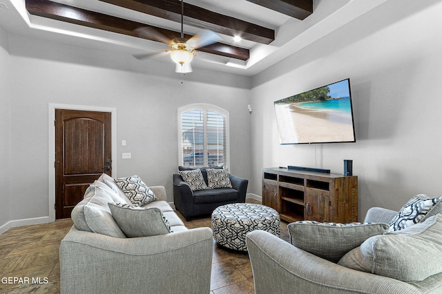 living room with ceiling fan and beamed ceiling