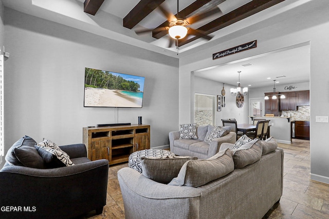 living room with ceiling fan with notable chandelier and beam ceiling